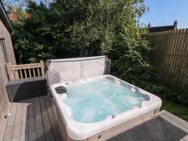 A hot tub on a deck area at Cornerstones Brython in Tenby