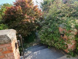 Steps leading down surrounded by plants at Cornerstones Brython in Tenby