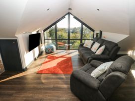A living room with a sofa and coffee table at 11 Brython Place in Tenby