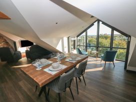 A dining room with a table and chairs at 11 Brython Place in Tenby