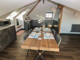 A kitchen with a dining table set for meals at 11 Brython Place Tenby