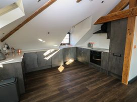 A kitchen with cabinets and appliances at 11 Brython Place in Tenby