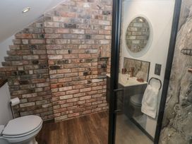 A bathroom with a toilet and shower at 11 Brython Place Tenby