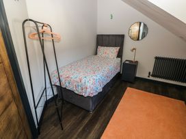 A bedroom with a bed and nightstand at 11 Brython Place Tenby