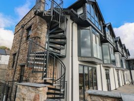An exterior view of a building with a spiral staircase at 11 Brython Place Tenby