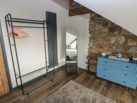 A bedroom with a clothes rack and a dresser at 11 Brython Place Tenby