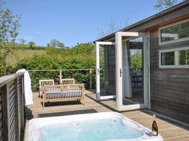 An outdoor area with a hot tub and seating at 7 Valley View, Lanreath