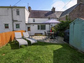 A garden with patio furniture and lawn at Bryn Tirion, Moelfre