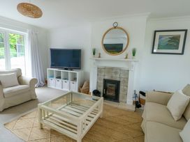 A living room with a television and fireplace at Bwthyn Clai in Llangefni