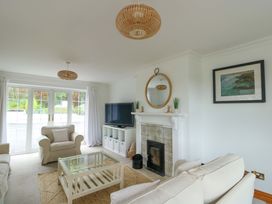 A living room with a fireplace and television at Bwthyn Clai in Llangefni