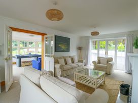 A living room with a sofa and armchairs at Bwthyn Clai in Llangefni