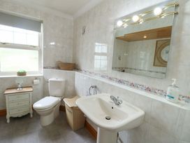 A bathroom with a toilet and washbasin at Bwthyn Clai in Llangefni