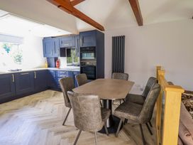 A kitchen with a dining table and chairs at Mallard Cottage in Penrith