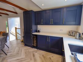 A kitchen with cabinets and appliances at Mallard Cottage in Penrith