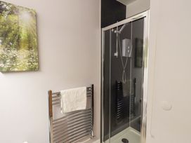 A bathroom with a shower and towel radiator at Mallard Cottage Penrith