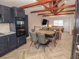A kitchen with dining area at Mallard Cottage in Penrith