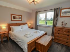 A bedroom with a double bed and dresser at Mallard Cottage Penrith