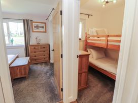 A bedroom with a bunk bed and a chest of drawers at Mallard Cottage Penrith