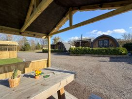 An outdoor area with huts and a table at No Deer in Ashbourne