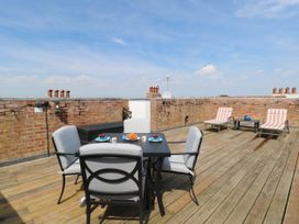 A roof terrace with table and chairs at Skylark in Southwold