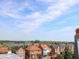 A view of houses and greenery from a rooftop at Skylark in Southwold