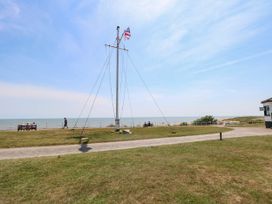 An outdoor area with a flagpole and a view of the sea at Skylark Southwold