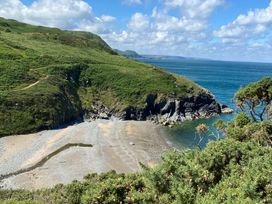 Coastline view with sand and ocean at Ty Bach Twt Synod Inn, near New Quay