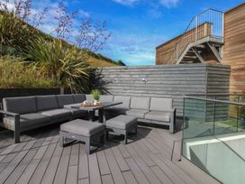An outdoor seating area with a sofa and coffee table at 7 Beachdown in Challaborough