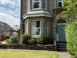 A house entrance with a green door and garden at The Furness Haven in Barrow-In-Furness