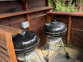 An outdoor kitchen with two barbecue grills at The Furness Haven in Barrow-In-Furness
