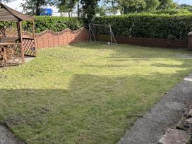 A garden with a gazebo and a goalpost at The Furness Haven in Barrow-In-Furness