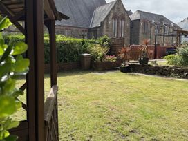A garden with plants and a house at The Furness Haven in Barrow-In-Furness