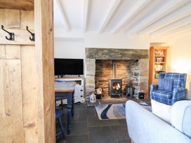 A living room with a fireplace and a TV at Ael Y Bryn in Ffestiniog