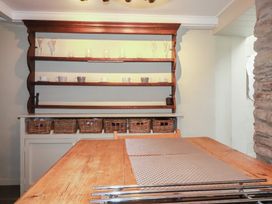A kitchen with shelves and a wooden table at Penvar in Truro