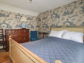 A bedroom with a bed and dresser at Penvar in Truro