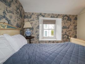 A bedroom with a bed and window at Penvar in Truro