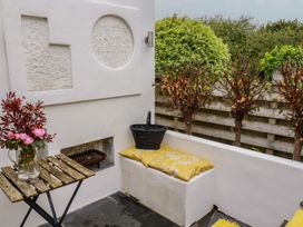 An outdoor seating area with a table and flowers at Penvar in Gerrans near Portscatho