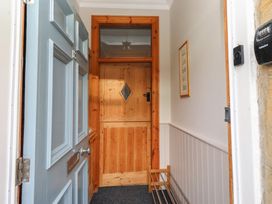 A hallway with a front door and internal door at Rose House Alnmouth