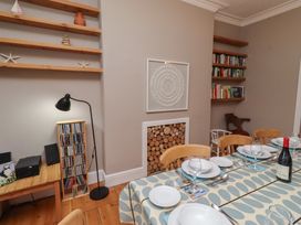 A dining room with a table set for a meal at Rose House in Alnmouth