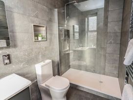 A bathroom with a shower, toilet, and sink at Rose House in Alnmouth