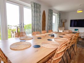 A dining room with a large table and chairs at Lavender House in Crantock