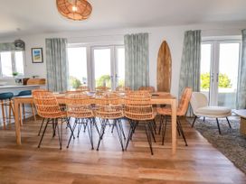 A dining room with a large table and chairs at Lavender House in Crantock