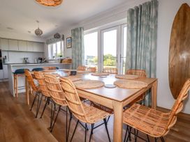 A dining room with a large table and chairs at Lavender House in Crantock