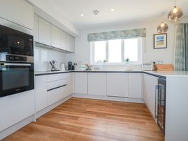 A kitchen with cabinets and appliances at Lavender House in Crantock