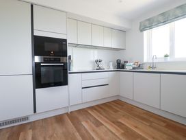 A kitchen with cabinets and appliances at Lavender House in Crantock