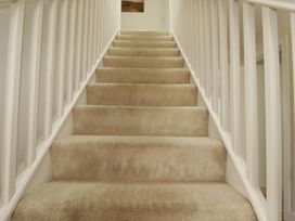 Stairs with carpet and railing at Lavender House in Crantock