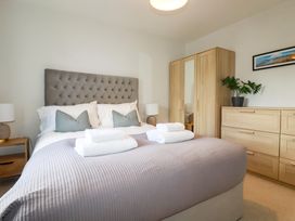 A bedroom with a bed and furniture at Lavender House in Crantock