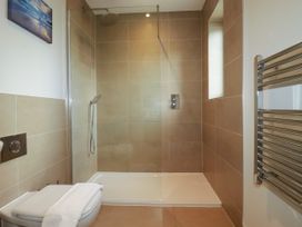 A bathroom with shower and towel rail at Lavender House in Crantock