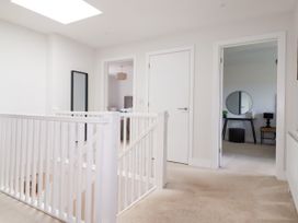 A hallway with stairs and doors at Lavender House in Crantock
