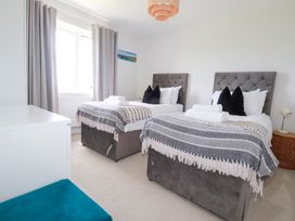 A bedroom with twin beds and a window at Lavender House Crantock
